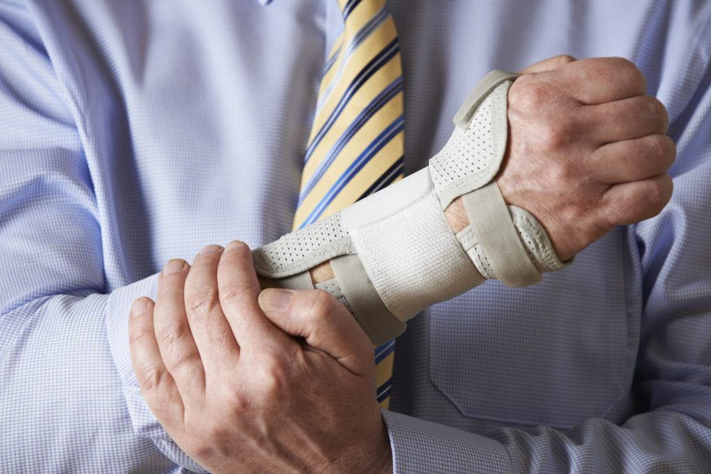 Close Up Of Businessman Suffering With Repetitive Strain Injury